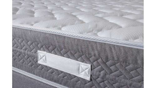 Detalle lateral gris acolchado y tejido superior del Colchón POSEIDÓN CHESTIA