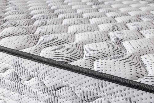 Detalle del acolchado blanco y gris del Colchón ZEUS CHESTIA